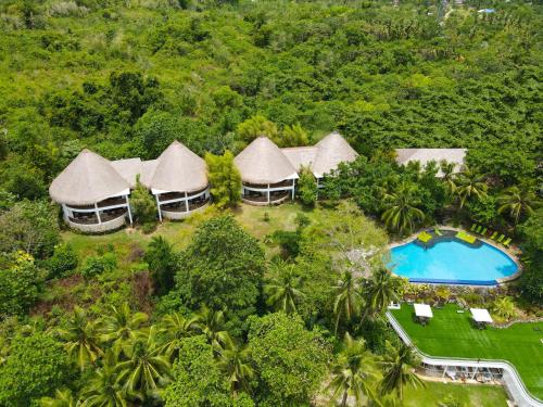 an aerial view of a resort with a swimming pool at Amun Ini Beach Resort & Spa in Anda