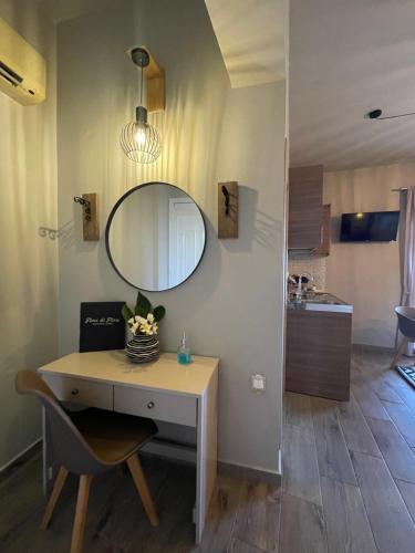 a bathroom with a vanity and a mirror on a wall at Fiore di Flora in Archangelos