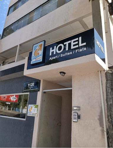 a hotel sign on the side of a building at Vila Suítes Coliving in Vila Velha
