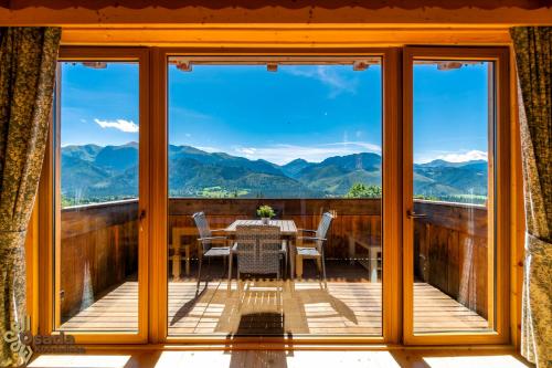a view from the balcony of a house with a table and chairs at Osada Kościelisko - Tatry na Wyciągnięcie Ręki in Kościelisko