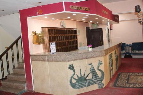 a restaurant with a bar with an anchor painted on it at Tiba Hotel in Aswan