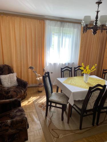 a living room with a dining room table and chairs at Domek U Babci in Myscowa