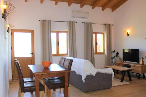 a living room with a couch and a table at Quinta das Alfambras in Aljezur