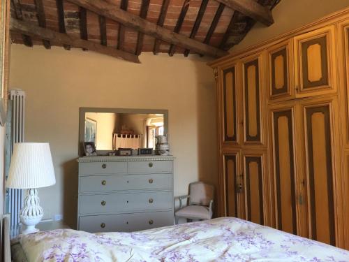 a bedroom with a bed and a dresser and a mirror at Attico con Terrazza panoramica vista lago - LAKEHOLIDAY IT in Castel di Tora