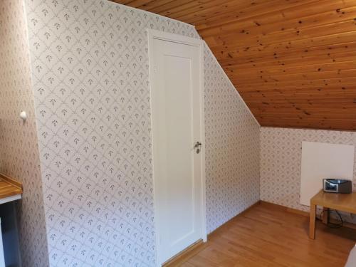 an open door in a room with a wooden ceiling at Molle Annexet -Lantlig Gastsvit i Rolfstorp in Rolfstorp