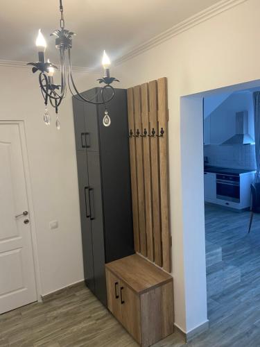 a room with a closet with a bench and a mirror at Casa Andreea in Sînmartin