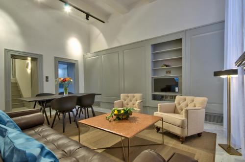 a living room with a couch and a table at 10 Strait Street Apartments in Valletta