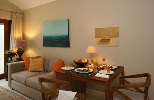 a living room with a couch and a table at Craighall Executive Suites in Johannesburg