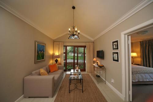 a living room with a couch and a bed at Craighall Executive Suites in Johannesburg