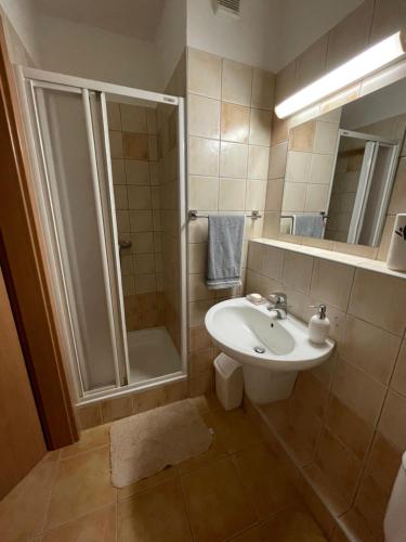 a bathroom with a sink and a shower at Joy Apartman in Zalakaros