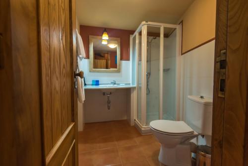 a bathroom with a toilet and a sink and a shower at Casa Perfeuto Maria in Cabana Moura 