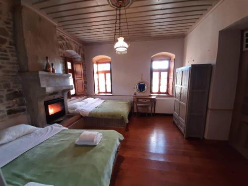 a large room with two beds and a fireplace at Lichovo in Papigko