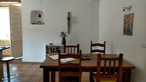 a dining room with a wooden table and chairs at Villa Ugijar in Ugíjar