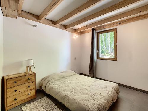 a bedroom with a bed and a window at T2 Robion luberon in Robion en Luberon