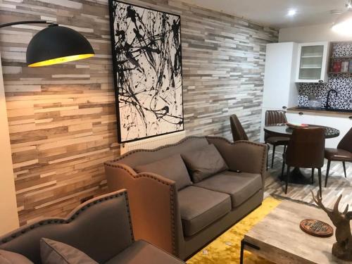 a living room with a couch and a table at Central Apartment - Moderna in Blairgowrie