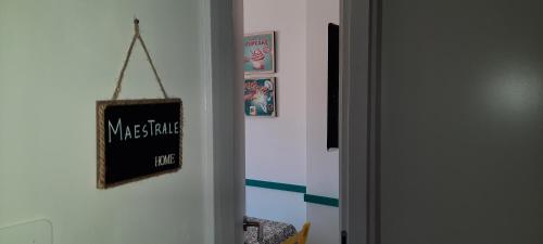 a door with a chalkboard sign on a wall at Casatua in Taranto