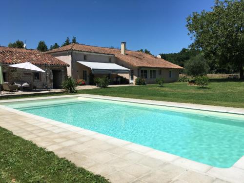 a swimming pool in front of a house at GITE clodeguy in Saint-Sylvestre-sur-Lot