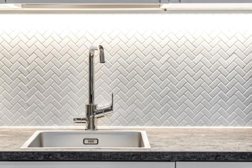 a kitchen sink with a silver chevron wallpaper at RukaValley Unique51 in Ruka