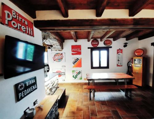 a dining room with a table and a tv in a building at IL SANTO GRAAL in Triora