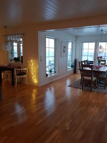 a living room with a table and a dining room at Villa Myklebostad in Sand