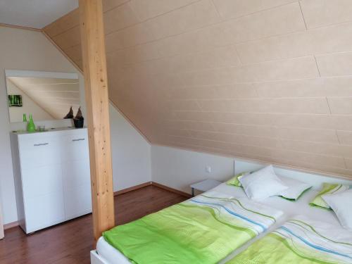 a bedroom with a bed in a attic at Ferienwohnung Burgblick in Lisberg
