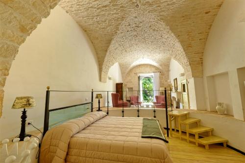 Posteľ alebo postele v izbe v ubytovaní Masseria Trulli e Vigne