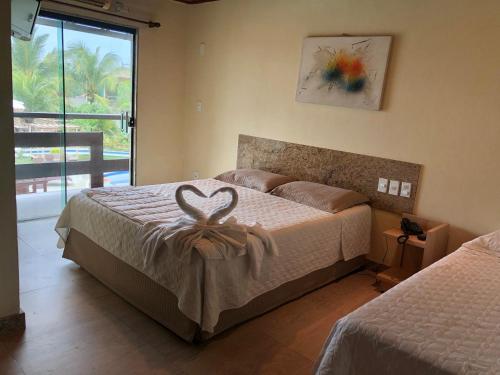 Postel nebo postele na pokoji v ubytování Porto Bali Hotel