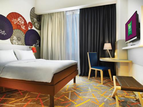 A bed or beds in a room at Ibis Styles Malang