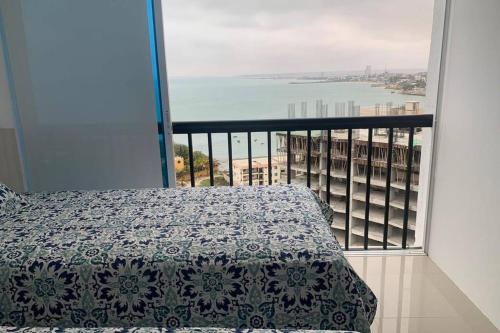 a bedroom with a bed and a view of the ocean at Suite de lujo Punta Centinela in La Libertad