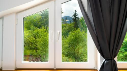 an open window with a view of trees at Stacja Sniezka in Karpacz