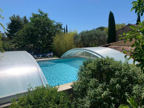 une piscine dans une cour avec une maison dans l'établissement Bastide Sainte Agnès, à Carpentras