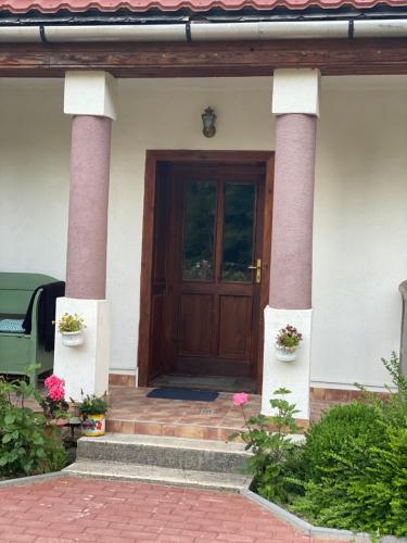 a front door of a house with two columns at Nagymama Vendégháza in Telkibánya
