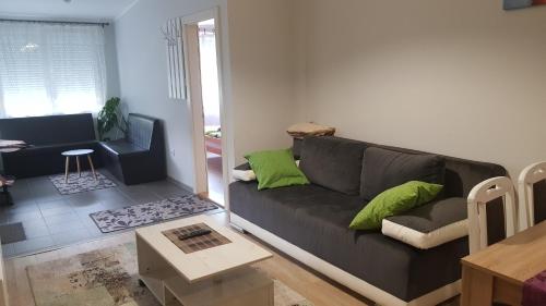 a living room with a couch and a table at Apartmani V&F in Vrnjačka Banja