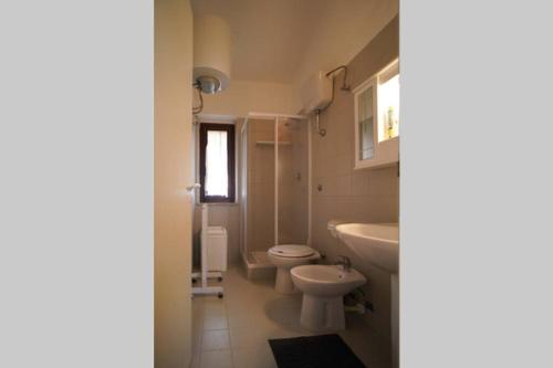 a bathroom with a sink and a toilet and a sink at Sea View Vista Mare - Soggiorni settimanali da sabato a sabato in Isola Capo Rizzuto
