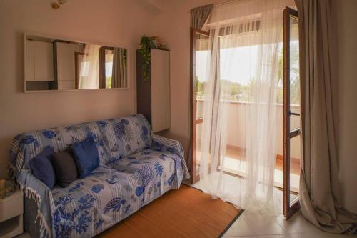a living room with a couch and a large window at Sea View Vista Mare - Soggiorni settimanali da sabato a sabato in Isola Capo Rizzuto