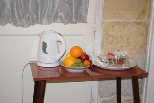a table with a juicer and fruit on it at Maria Townhouse Heart of Victoria B&B in Victoria