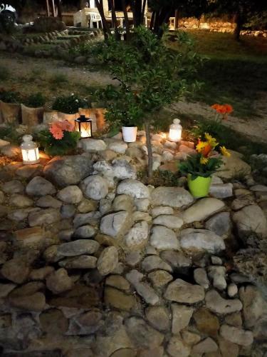 a rock garden with flowers and candles on it at Casale del Sole in Cepagatti