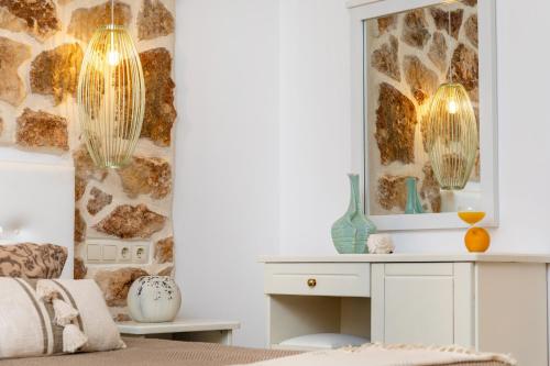 a bedroom with a mirror and a white dressing table at GOLDEN COAST NAXOS in Agios Prokopios