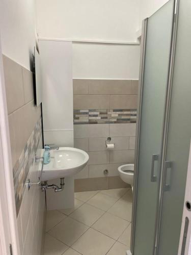 a bathroom with a sink and a toilet at Blu Mare House in Cecina