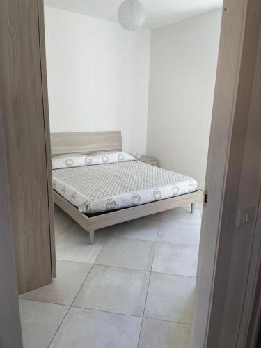 a bedroom with a bed in the corner of a room at Blu Mare House in Cecina