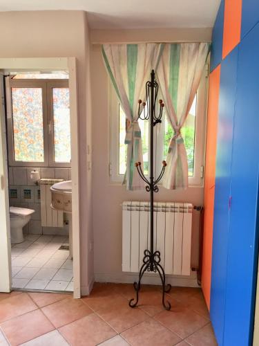 a bathroom with a pole in the middle of a room at Casa SERGIO Budva Rooms & Apartments in Budva