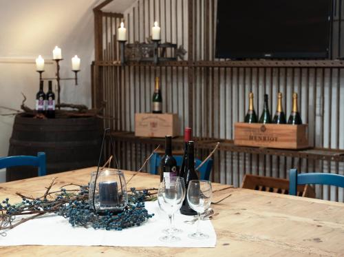 a table with wine bottles and glasses on it at Hofgut Wißberg - Das Weinberghotel in Sankt Johann