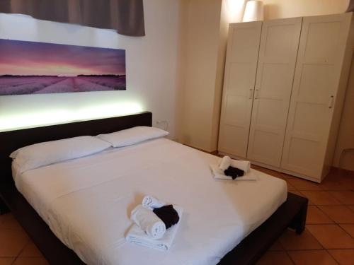 een slaapkamer met een wit bed en handdoeken bij Casa Anna in Specchia