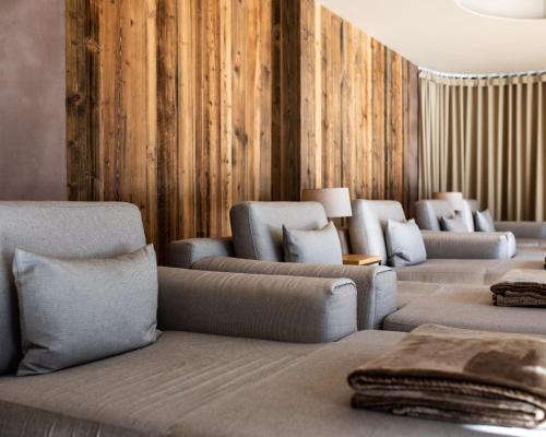 a row of couches and chairs in a waiting room at Hotel Cristallo in Solda
