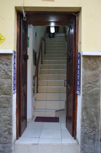 a stairway leading up to a building with stairs at Wild Incas Hostel in Cuenca
