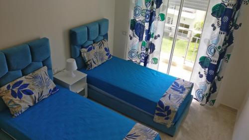Un pat sau paturi într-o cameră la Casabay Appart Vue Sur Piscine