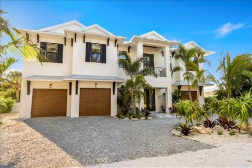 a large white house with two garage doors at Our Great Escape home in Anna Maria
