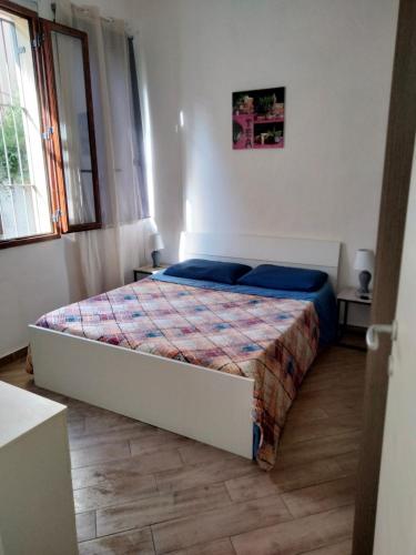 a bedroom with a bed in a room at La casa di sara in Nuoro