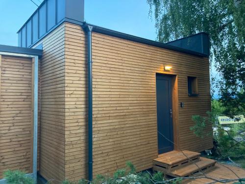 a tiny house with a black roof at Retro chaty Soběšky in Horní Soběšovice