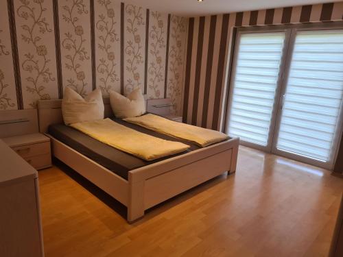 a bedroom with a bed in a room with a window at FeWo Reiswich in Cochem